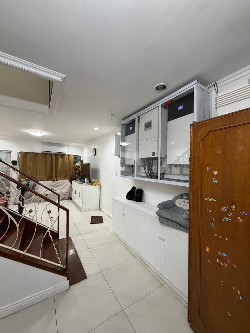 The cabinet along the upper wall by the stairwell, cabinet door on the right.